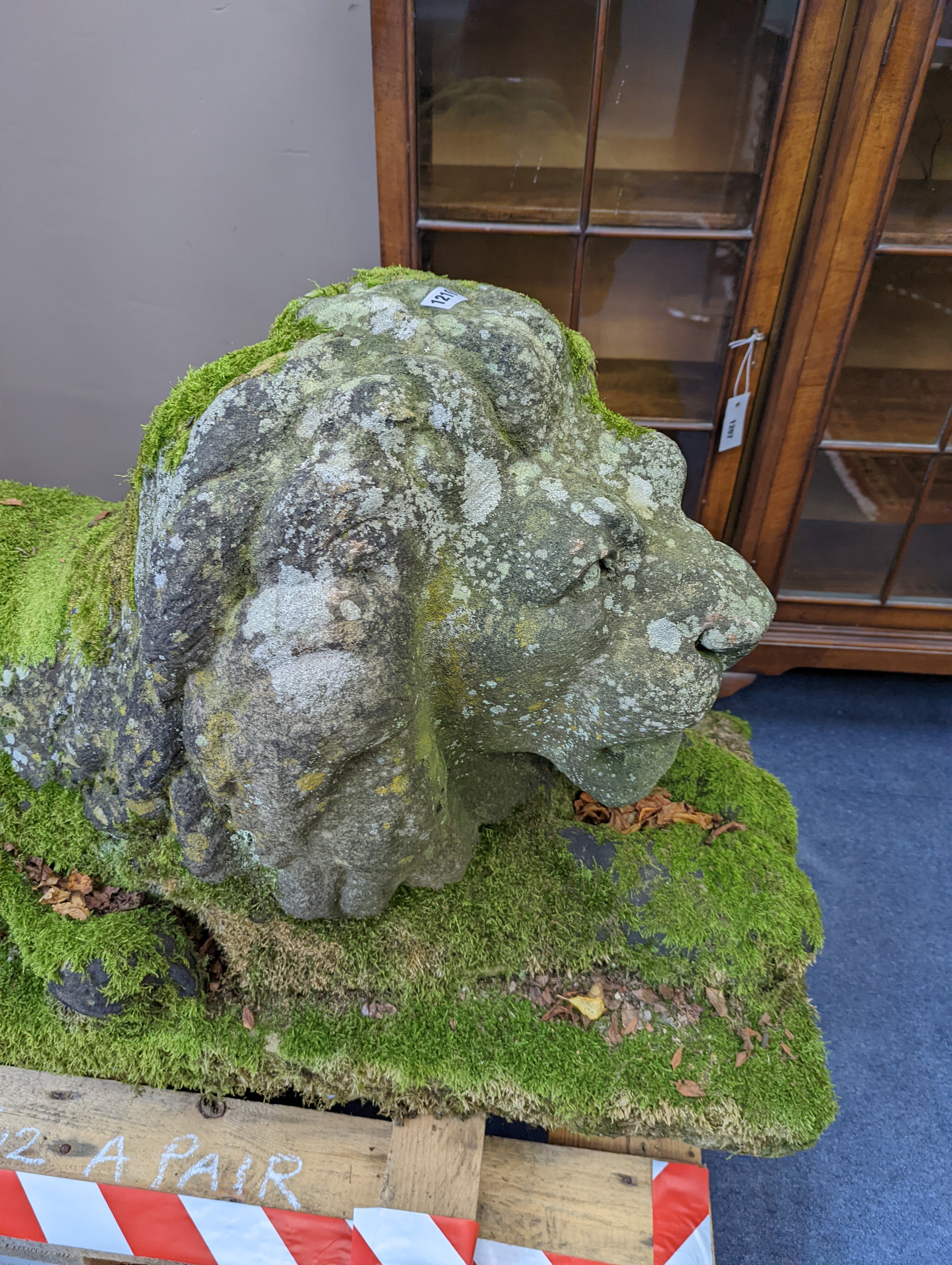 A pair of carved stone models of a recumbent lion and lioness, purchased from Crowther of Syon Lodge approximately 40 years ago. Length 122cm. Width 50cm. Height 60cm.